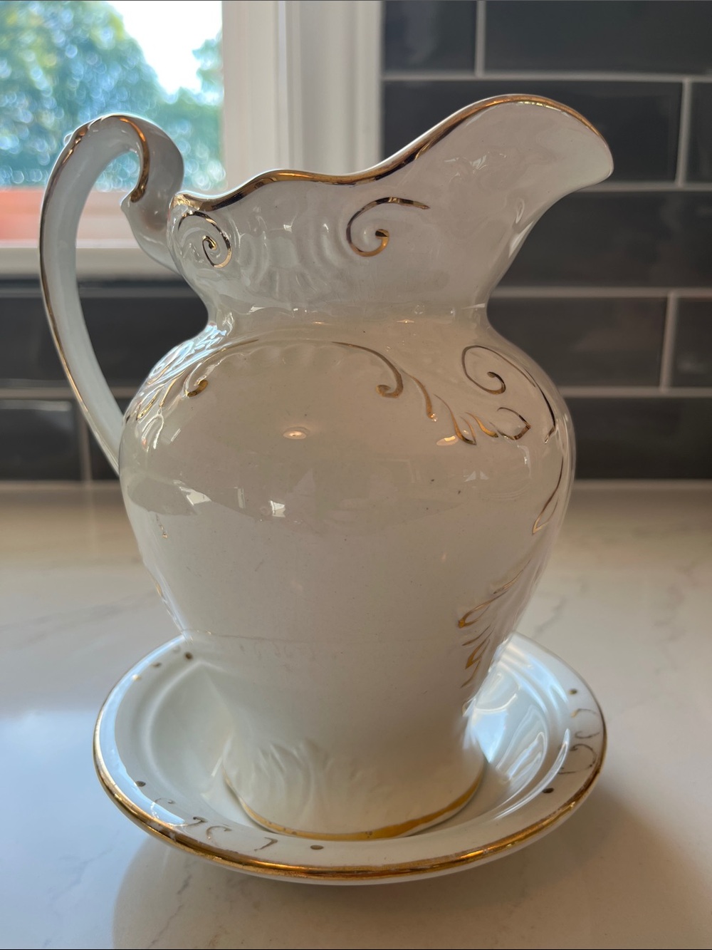 Elegant White Ceramic Pitcher with Gold Trim and saucer